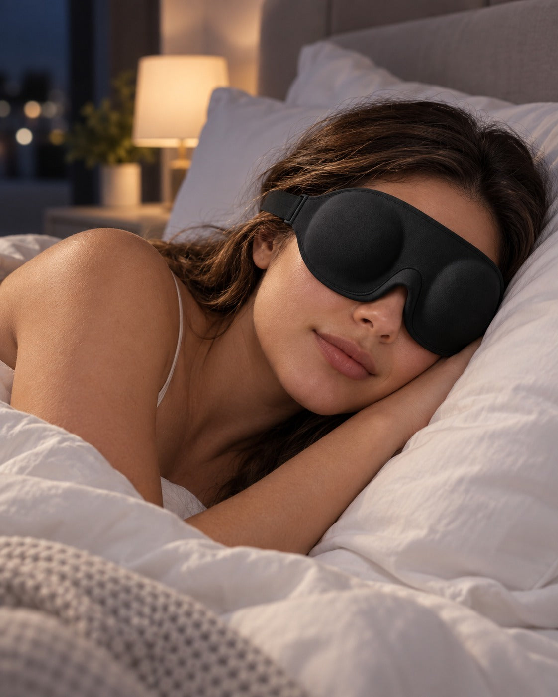 Woman sleeping on her side at night wearing the Pillow-Side contoured sleep mask